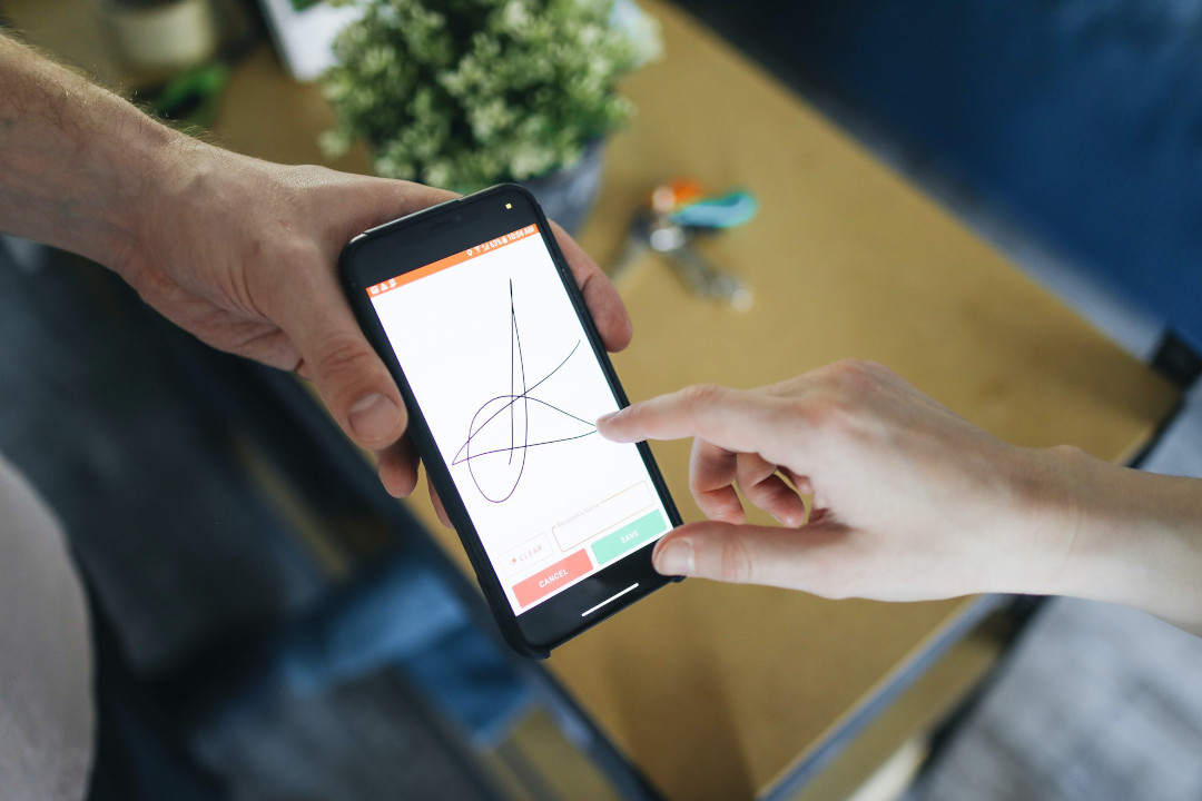 Person using smartphone to sign a document